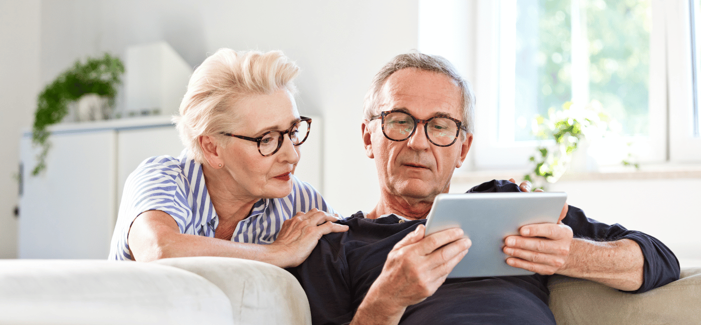 Old couple looking at their iPad